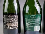 three bottles of wine sitting next to each other on a table