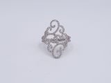 a close up of a diamond ring on a white surface