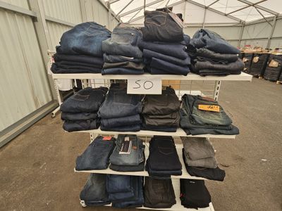 a lot of jeans on the shelves in the store