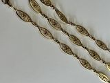 three pieces of jewelry on a white surface
