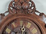 a wooden clock with roman numerals on the face