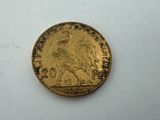 a close up of a gold coin on a white surface