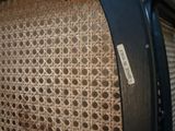 a close up of a chair with a wicker seat on it
