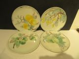 trois assiettes ornées de fleurs, posées sur une table