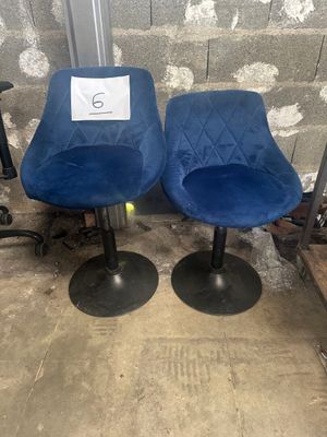 pair of blue swivel chairs with a price tag on them