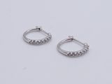 pair of diamond hoop earrings on white background