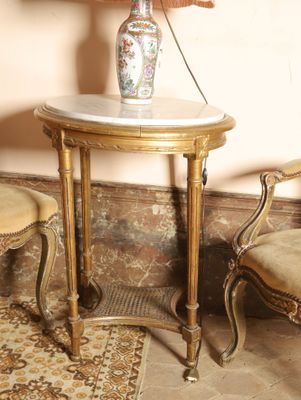 two chairs and a table with a lamp on top of it