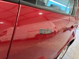 a red car that has a sticker on the side of it