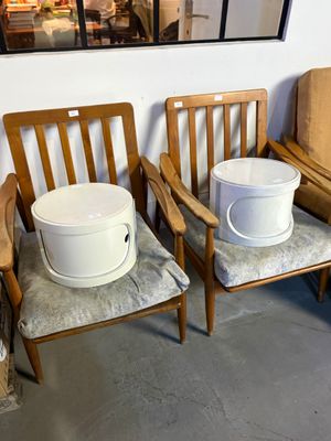 two chairs with buckets on them in a room