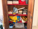 a large wooden cabinet with many items in it