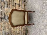 a chair that is sitting on the side of a stone wall