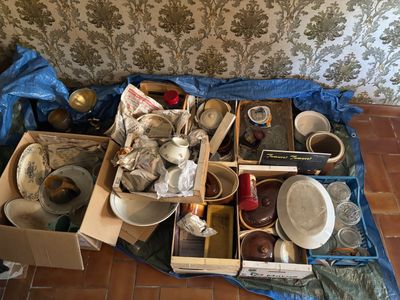 a pile of dirty dishes and pans on the floor