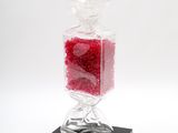 a glass vase with a red substance inside of it