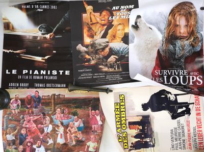 many movie posters on the wall of a room
