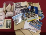 une pile de cartes postales posée sur une table recouverte d'une nappe rouge