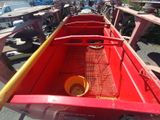 a red wagon with a yellow bucket in the back of it
