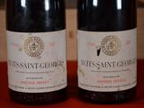 two bottles of wine that are sitting on a table