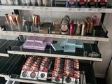 a lot of makeup products on the shelves in the store