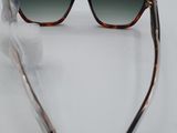 a pair of sunglasses on a white surface with a feather