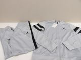a close up of a white jacket and pants on a table