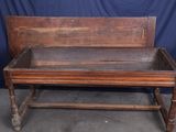 a wooden bench that is sitting in front of a blue backdrop