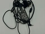 a black charger with a cord attached to it on a white surface