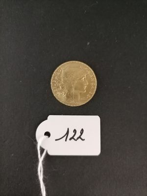 a gold coin on a black surface with a price tag