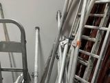 a pile of ladders and a chair in a room