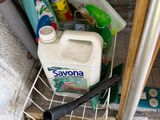 a basket full of cleaning supplies on the floor