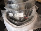 a pile of electronic equipment wrapped in plastic on the floor