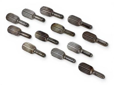 a lot of screws that are on a white surface