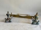 pair of antique brass candlesticks with birds on top of them