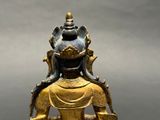 an image of a gold statue of a person with a bird on his head