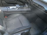 the interior of a car with a black leather seat and dashboard