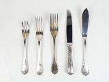 four forks and a knife on a table