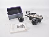 a camera and a box on a white surface