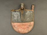 a small shovel with a long handle on the wall