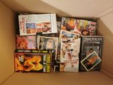 a cardboard box filled with various movies and dvds