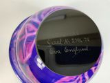 a purple and blue vase with writing on it