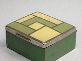 a small green box with a yellow and yellow design on it
