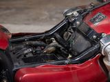 a close up of a red motorcycle with its engine in the back
