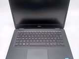 a laptop with a keyboard on it sitting on a table