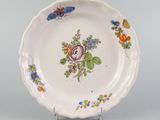 a white plate with flowers and butterflies on it