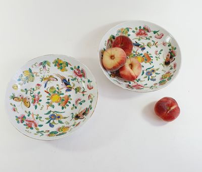 two bowls of fruit sitting on a table next to each other