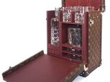 an image of a suitcase with a liquor set inside of it