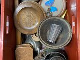 a red box filled with assorted items on the floor