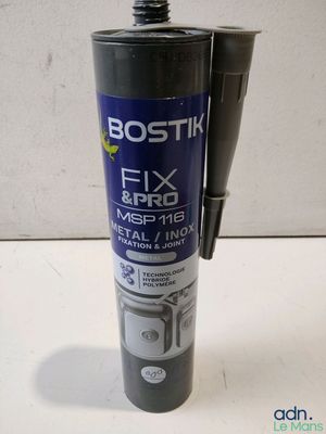 a close up of a bottle of fix and fix glue on a table