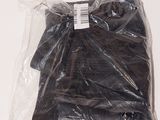 a bag of black clothing on a white surface