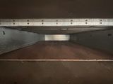 a close up view of an oven door with the door open