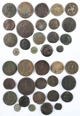 an assortment of ancient coins on a white surface